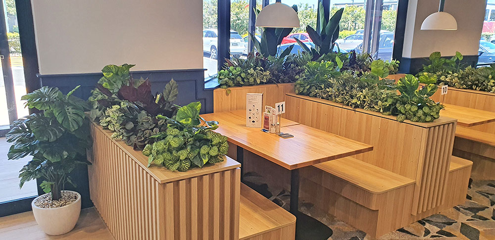 low greenery in booth planters