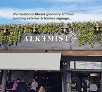 UV-treated artificial greenery softens Cafe facade & frames signage...