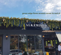 UV-treated artificial greenery softens Cafe facade & frames signage...