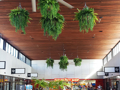 Lush green & dazzling lights- huge artificial hanging-baskets in shopping centre