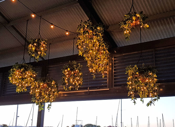 Hanging-Baskets with lights brighten up marina restaurant... image 7
