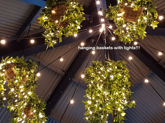 Hanging-Baskets with lights brighten up marina restaurant... image 8