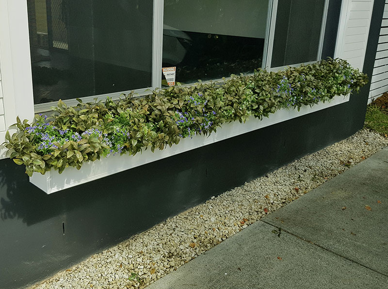 UV-treated artificial plants dress-up commercial building facade...