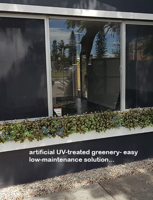 UV-treated artificial plants dress-up commercial building facade...