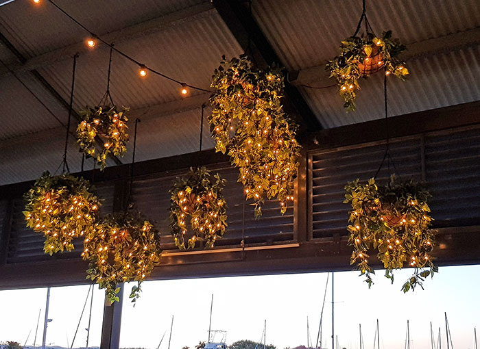 Hanging-Baskets with lights brighten up marina restaurant...