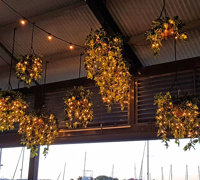 Hanging-Baskets with lights brighten up marina restaurant...