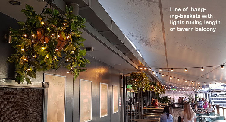 Hanging-Baskets with lights brighten up marina restaurant...