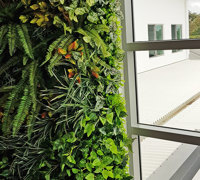 Ugly block support walls turned into lush green-screens with artificial plants