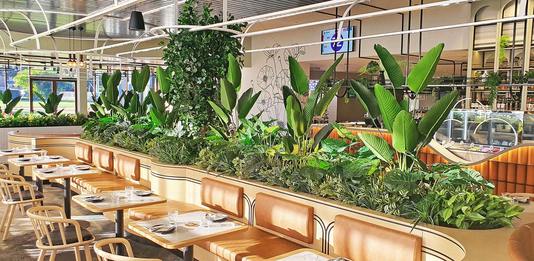 long planter breaks up areas in large club dining area