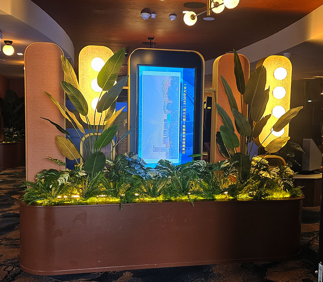 A stunning combo of lights & plants in this entry barrier planter 