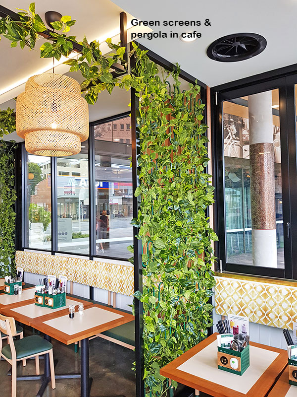 Cafe uses artificial green-vines for privacy screens & pergolas image 6