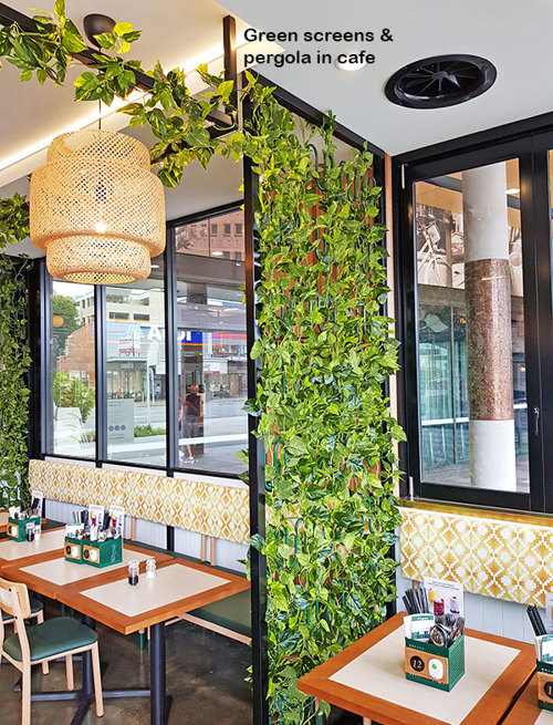 Cafe uses artificial green-vines for privacy screens & pergolas