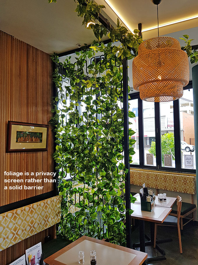 Cafe uses artificial green-vines for privacy screens & pergolas image 3