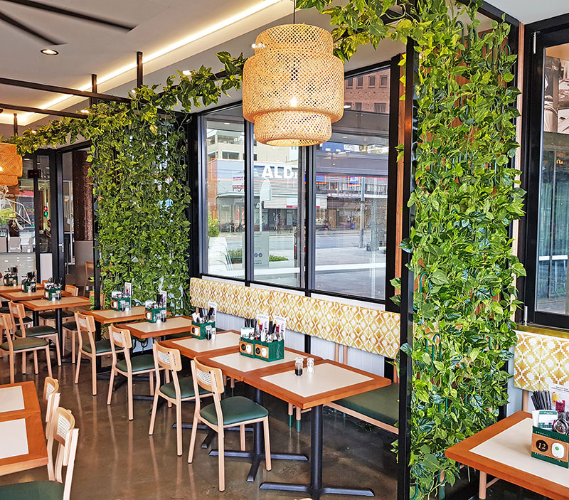 Cafe uses artificial green-vines for privacy screens & pergolas image 4