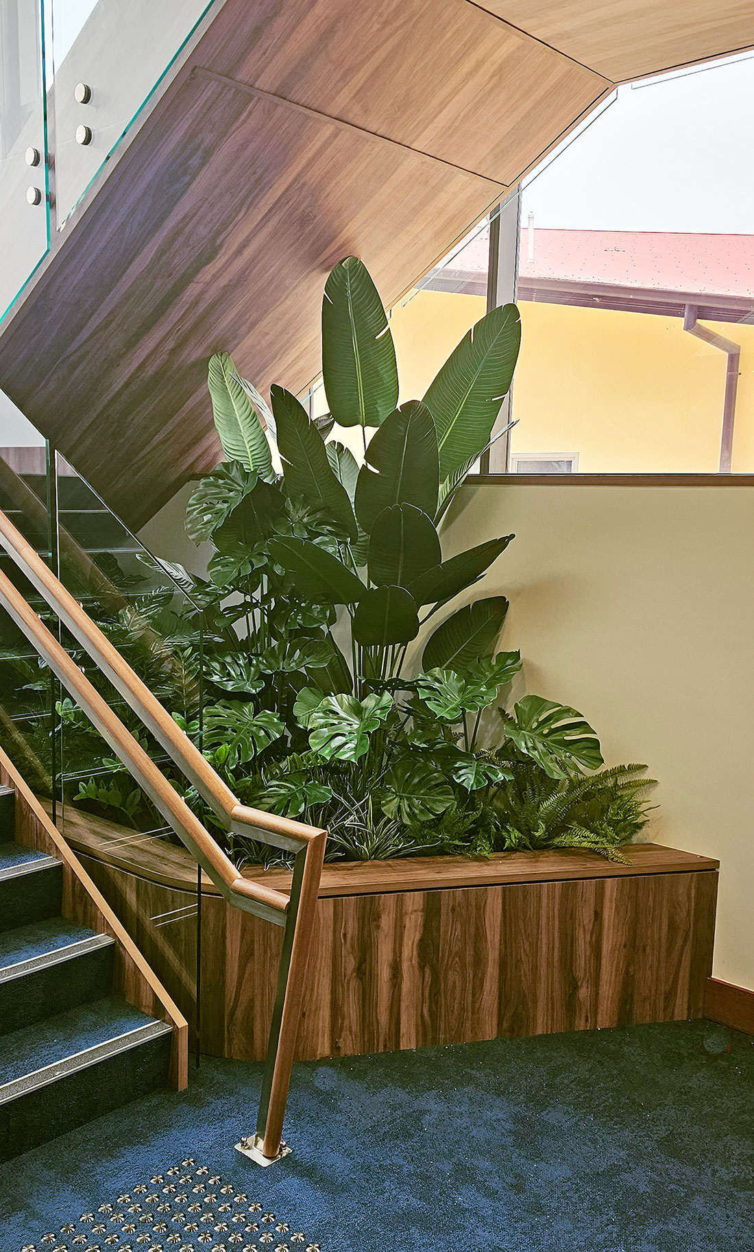 A stairway planter with lush mixed foliage